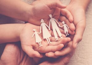 paper family figures in hands