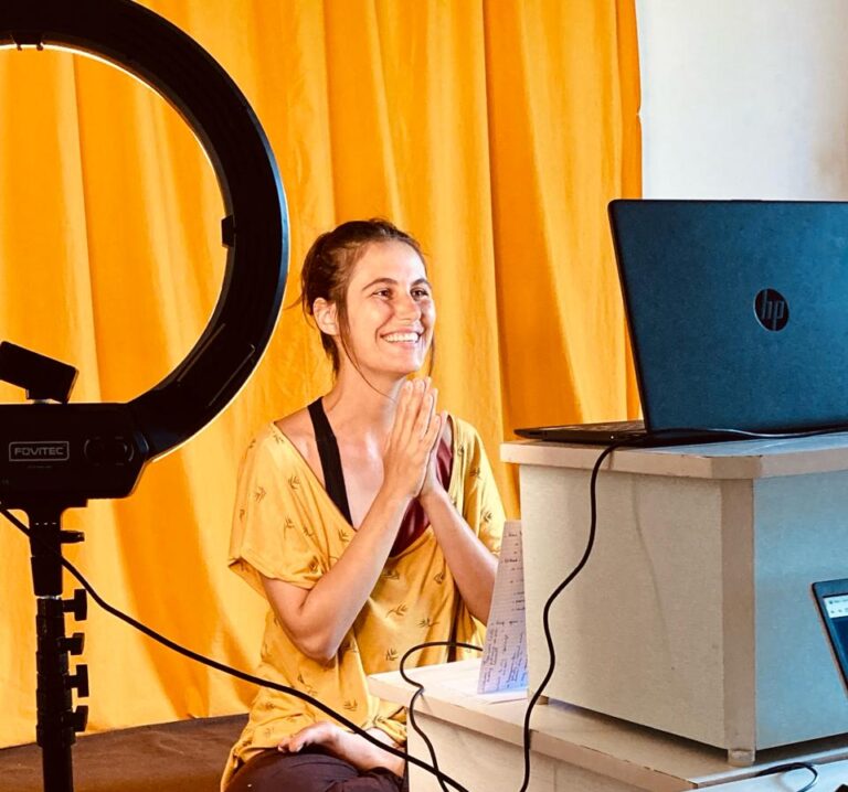 Yoga teacher teaching online asana class